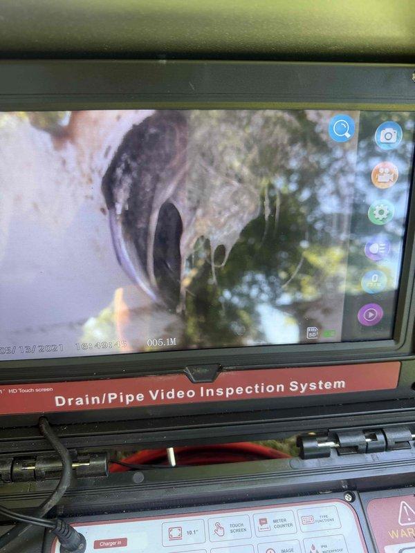 Responded to gurgling issue in main bathroom that had been occurring for approximately six weeks. Performed comprehensive video camera inspection of the sewer line to identify potential blockages or venting problems causing air in the system. Inspection revealed no major obstructions in the main drain line, with toilet flushing properly despite gurgling sounds indicating a possible venting issue. Conducted thorough inspection of water supply lines and sewer lines throughout the property. Examined crawl space plumbing infrastructure, noting PEX water lines that were previously replaced nine years ago. Inspected exterior hose bibs and discovered one loose spigot requiring attention and identified galvanized piping on another exterior faucet that may not have been included in previous water line replacement work. Documented all findings with photographic evidence of pipe inspection system results and crawl space plumbing configuration. Provided recommendations for toilet replacement as re
