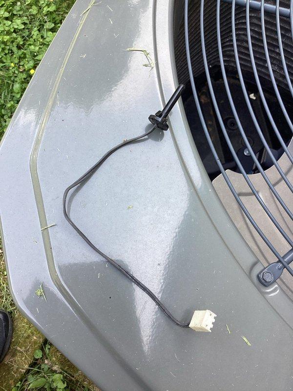 Returned to site with correct ambient temperature sensor after incorrect part was ordered previously. Replaced faulty sensor on outdoor heat pump unit and verified proper operation of system controls.