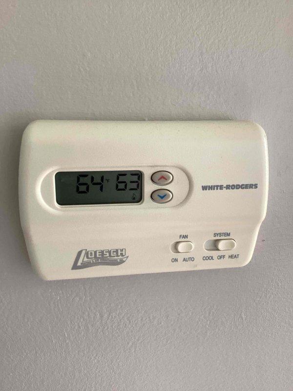 Completed basic monthly cooling maintenance on residential HVAC system. Inspected wall-mounted White-Rodgers thermostat confirming proper operation and display functionality, verified furnace/air handler unit and associated components in mechanical room, and documented equipment condition with photos. Filter size was unable to be determined during this visit.