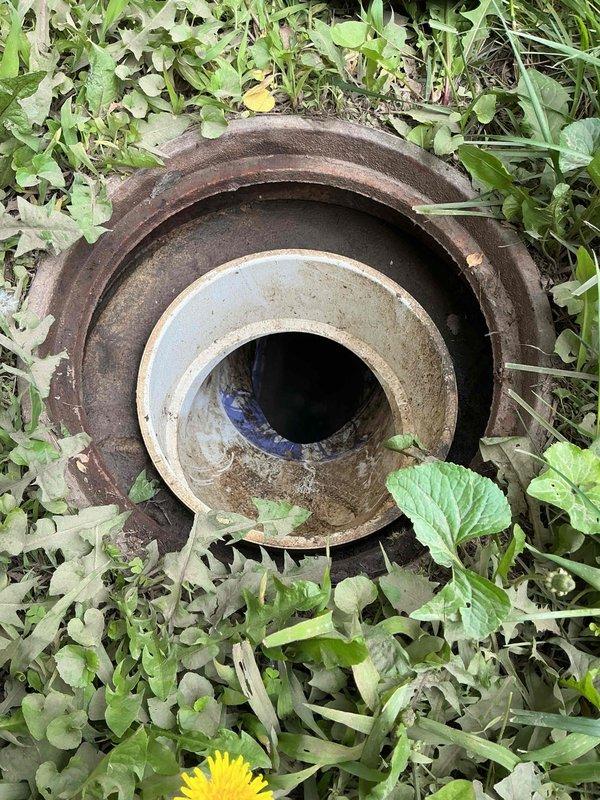 Installed new clean out access point in exterior plumbing system. Removed existing deteriorated metal and concrete assembly showing extensive rust and corrosion, then replaced with new clean out fitting to provide proper access for future drain maintenance and clearing of blockages.