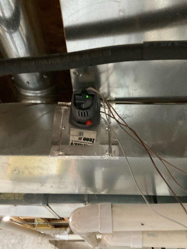 Conducted comprehensive estimate for complete HVAC system replacement at residential property, including new furnace and air conditioning unit installation. Evaluated existing attic-mounted equipment and ductwork configuration, documenting current system components including Honeywell motorized damper control unit (Model ZD20X8/U) with manual override capability and zone control devices with LED indicators. Assessed metallic ductwork with reflective foil-faced insulation, flexible ducting connections, and electrical wiring infrastructure to determine compatibility requirements for new equipment installation and identify any necessary modifications to existing air distribution network.