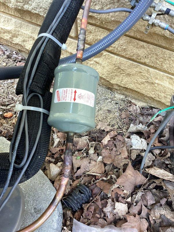 Returned to site with R-454B refrigerant to address refrigerant leak in outdoor condensing unit. Located and repaired leak in refrigerant line, then installed new filter drier to ensure system cleanliness. Evacuated system to proper micron level, recharged unit with R-454B refrigerant to manufacturer specifications, and verified all pressures and system operation were within normal parameters.