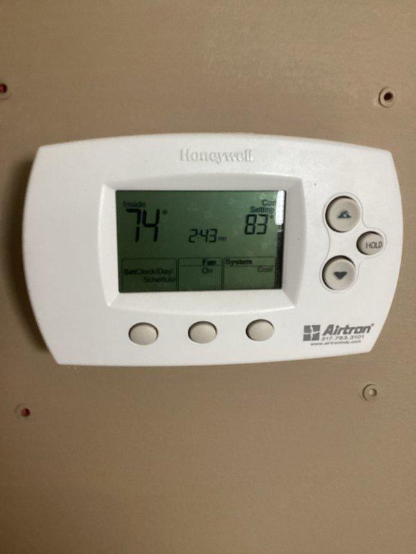 Responded to service call for dual-unit HVAC system at property currently listed for sale. Performed comprehensive inspection of both air conditioning systems to assess operational status and identify reported seasonal startup issues. Documented system conditions including thermostat functionality showing 74°F setpoint with 83°F ambient temperature, and photographed furnace installation with PVC venting and ductwork configuration for record-keeping purposes.