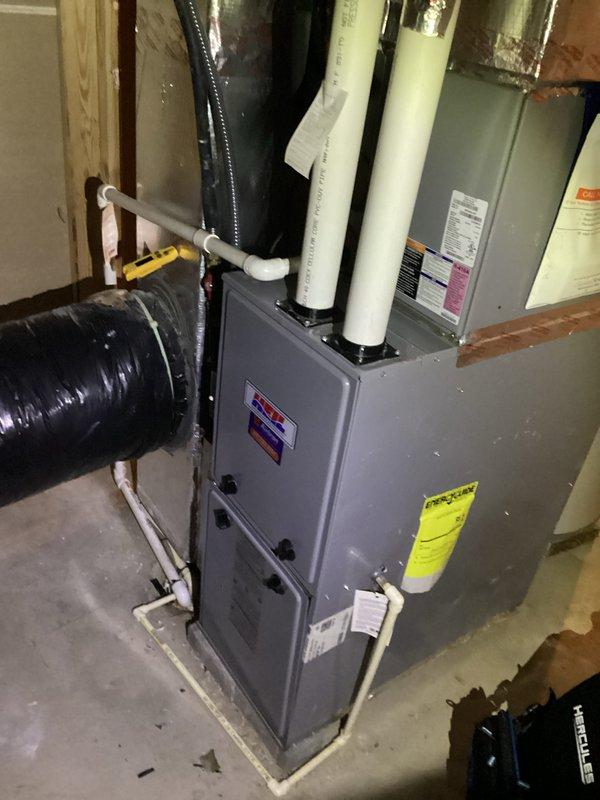 Responded to service call for dual-unit HVAC system at property currently listed for sale. Performed comprehensive inspection of both air conditioning systems to assess operational status and identify reported seasonal startup issues. Documented system conditions including thermostat functionality showing 74°F setpoint with 83°F ambient temperature, and photographed furnace installation with PVC venting and ductwork configuration for record-keeping purposes.
