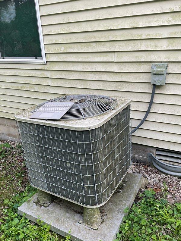 Completed HVAC replacement estimate for an 18-year-old residential air conditioning system with a failed compressor. Assessed the outdoor condenser unit showing significant age-related deterioration, including heavy moss and lichen growth on components, and determined the system was beyond economical repair. Provided cost-effective replacement options suitable for the customer's budget constraints.
