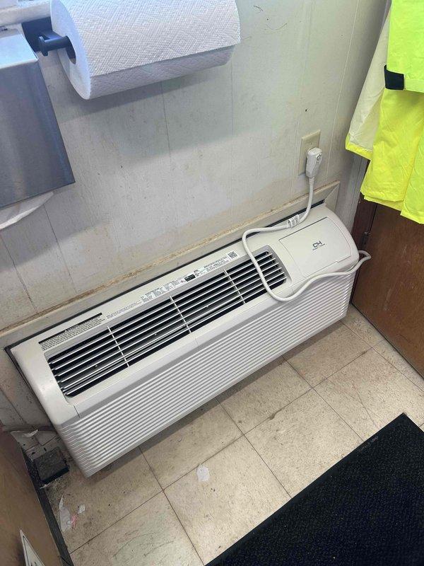 Responded to service call for wall-mounted PTAC unit with reported refrigerant leak concerns and odor complaints causing discomfort. Performed visual inspection of unit, checked electrical connections and power supply, and documented unit condition with photographs. Unit was found to be powered off at time of inspection; recommended further diagnostic testing including refrigerant leak detection and air quality assessment to identify source of reported issues.