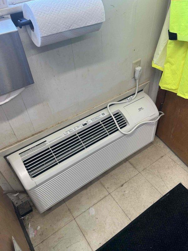 Responded to service call for wall-mounted PTAC unit with reported refrigerant leak concerns and odor complaints causing discomfort. Performed visual inspection of unit, checked electrical connections and power supply, and documented unit condition with photographs. Unit was found to be powered off at time of inspection; recommended further diagnostic testing including refrigerant leak detection and air quality assessment to identify source of reported issues.
