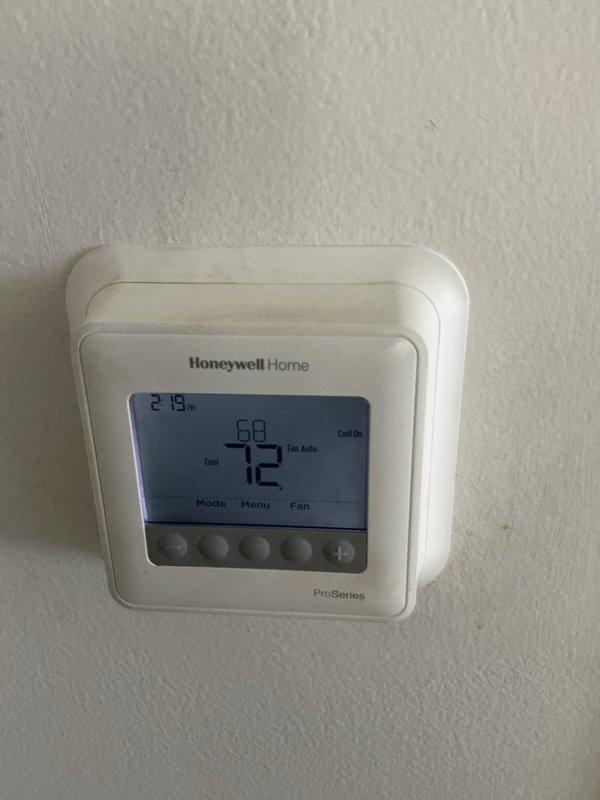 Completed comprehensive cooling maintenance inspection on residential HVAC system. Verified thermostat operation showing system actively cooling with setpoint at 68°F and current temperature at 72°F in auto fan mode. Inspected outdoor condensing unit with protective wire mesh cage, confirmed proper placement on equipment pad with adequate clearance from surrounding landscaping. Documented equipment conditions through photographic records. Customer reported filter size unknown for monthly basic maintenance service; unable to complete filter replacement without proper size specifications.