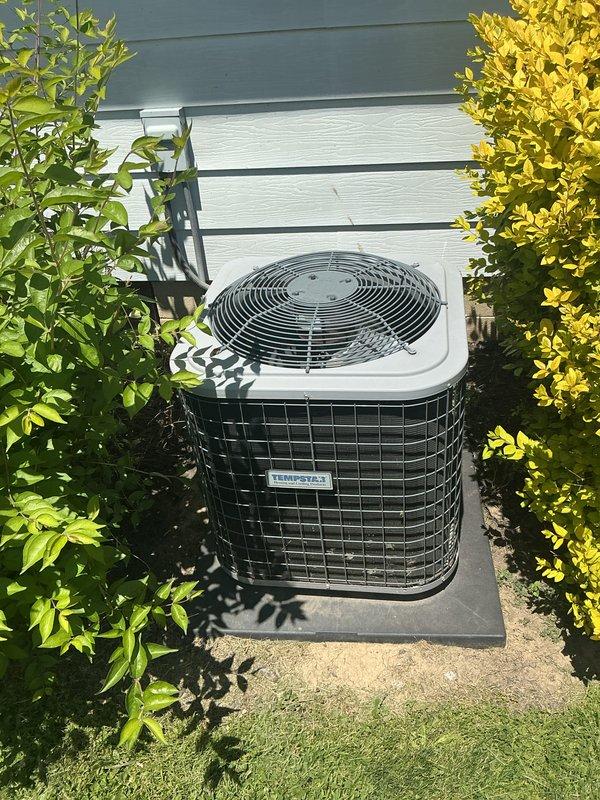 Completed comprehensive cooling maintenance inspection on residential HVAC system. Verified thermostat operation showing system actively cooling with setpoint at 68°F and current temperature at 72°F in auto fan mode. Inspected outdoor condensing unit with protective wire mesh cage, confirmed proper placement on equipment pad with adequate clearance from surrounding landscaping. Documented equipment conditions through photographic records. Customer reported filter size unknown for monthly basic maintenance service; unable to complete filter replacement without proper size specifications.