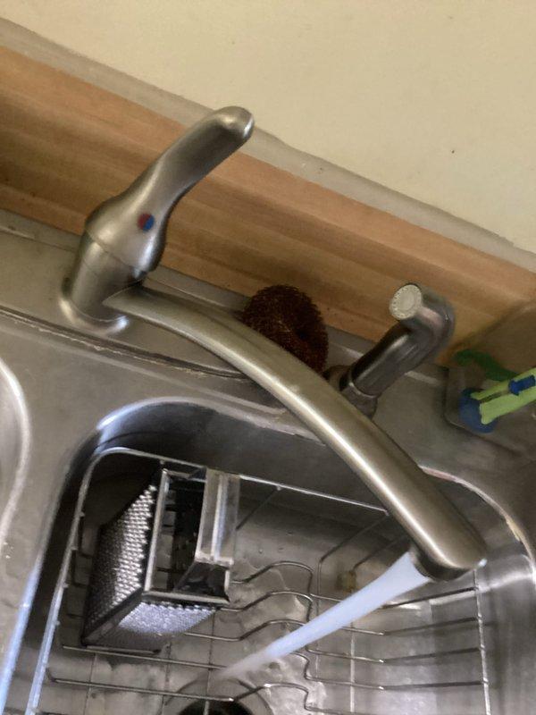 Completed routine plumbing membership maintenance inspection with no issues reported by customer. Inspected kitchen sink, faucet assembly, and visible plumbing connections in utility area, documenting all fixtures and drain systems in proper working order. All components photographed for service records.