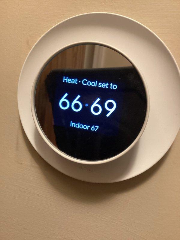 Performed routine HVAC maintenance and system evaluation. Verified thermostat operation showing heat and cool settings with indoor temperature reading of 67°F and setpoint range of 66-69°F. Confirmed system temperature readings using calibrated digital thermometer showing 66.1°F, validating proper thermostat accuracy and climate control functionality.