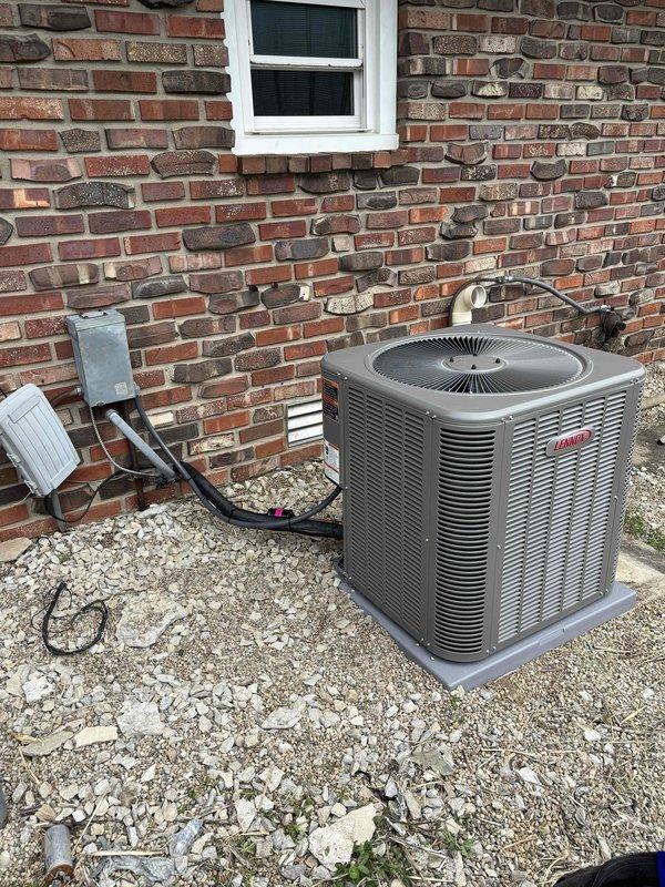 # HVAC Install - Complete System

Completed full installation of Lennox air conditioning and LP furnace system at residential property. Outdoor condenser unit positioned on gravel pad against brick exterior wall with proper clearances maintained. Installed insulated refrigerant line set running from condenser to indoor air handler, secured along foundation and exterior wall. Mounted condensate safety switch with overflow protection on bracket attached to brick wall. Ran electrical conduit and wiring to power outdoor unit per manufacturer specifications and local code requirements.

Indoor furnace installation included complete gas line connection for LP operation. Performed pressure testing using dual port manometer to verify proper gas pressure at 11.6 mbar. Completed all electrical connections at furnace control board including low voltage thermostat wiring and high voltage power supply. Verified proper polarity and secure connections at all wire terminations.

System startup procedu