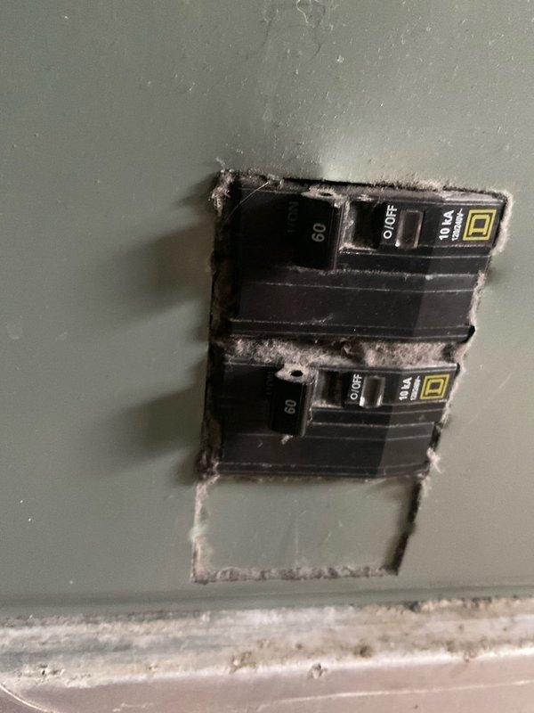 Conducted comprehensive site evaluation for full HVAC system replacement in basement utility area. Performed load calculation assessment on existing vertical air handler unit with multiple stacked components and ceiling-mounted ductwork distribution system. Documented current equipment configuration including gray metal air handler installation against interior wall with sheet metal supply ductwork connections. Inspected electrical service supplying HVAC system, noting dual 60-amp circuit breakers with visible dust accumulation requiring attention during replacement. Prepared complete system replacement estimate with expedited timeline for installation within one week per customer requirements.