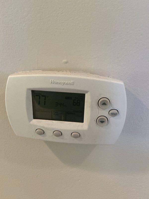 Completed monthly basic cooling maintenance visit on residential Carrier air conditioning system. Performed visual inspection of outdoor condenser unit, verified operational status, and checked thermostat programming showing system cooling from 77°F to setpoint of 68°F. Unit operating normally with no issues identified during this routine preventative maintenance service.