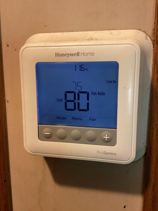 Responded to service call for frozen refrigerant line and unusual system noises. Upon arrival, performed visual inspection of air conditioning system and identified severely restricted airflow due to heavily contaminated evaporator coil with significant dust accumulation and debris buildup on lower fins. Cleaned evaporator coil thoroughly to restore proper airflow, checked refrigerant charge and operating pressures, verified thermostat operation showing system set to cooling mode at 80°F setpoint with current temperature at 75°F. System returned to normal operation with no unusual noises and proper cooling cycle confirmed.