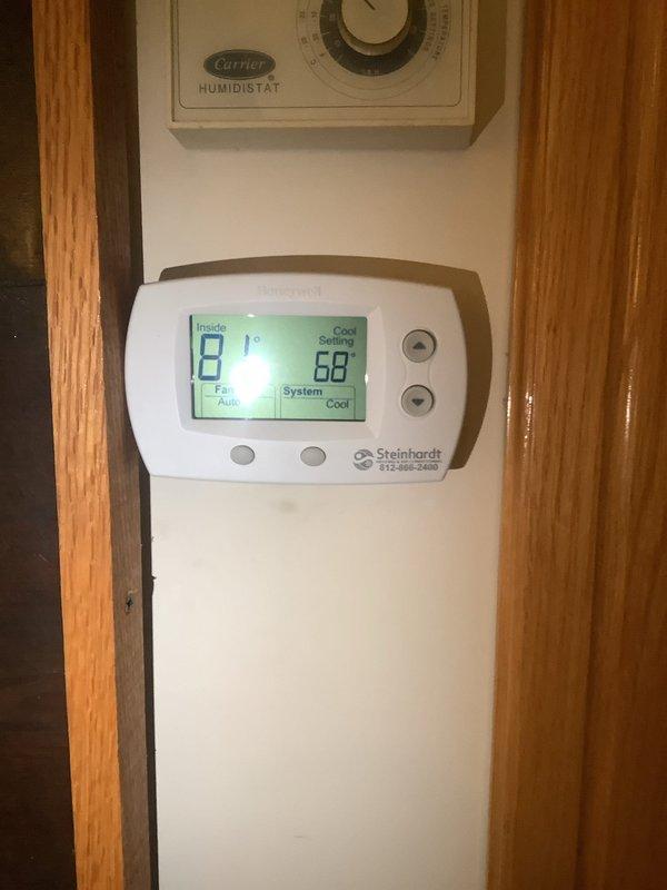 Responded to no-cooling complaint with outdoor unit not operating. Performed diagnostic inspection of air conditioning system, verified thermostat operation showing 81°F indoor temperature with cooling demand set at 68°F. Inspected outdoor condensing unit, interior components, refrigerant lines, and electrical connections. Documented system configuration and current operating conditions with interior panel access and thermostat settings for service records.