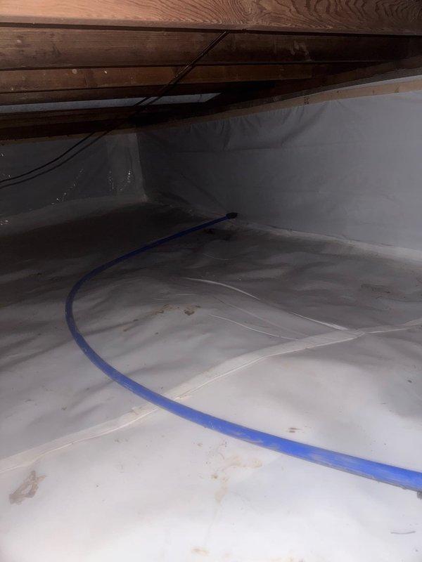 Completed full replacement of main water service line from meter to residence, removing all existing galvanized and copper piping to eliminate corrosion issues and improve water quality. Installed new blue PEX water supply line through crawl space, properly secured to floor joists with appropriate fastening clips to ensure long-term stability and prevent sagging. Replaced sewer line from existing cleanout connection point to home, upgrading drainage system for improved flow and reliability. All work performed in crawl space environment with proper vapor barrier protection in place. New plumbing infrastructure integrated with existing PVC drain lines and connections, ensuring compatibility with current system. Installation meets current plumbing codes for residential water supply and waste removal systems.
