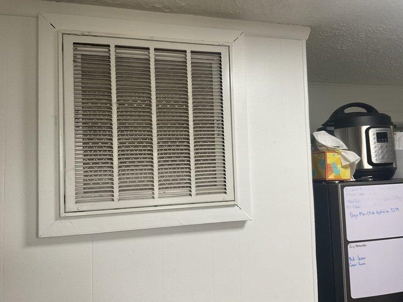 Evaluated residential property for central air conditioning installation where existing furnace and ductwork are present but no AC system currently installed. Assessed utility closet space containing white furnace unit with metal plenum, confirmed adequate return air ventilation, and verified existing duct infrastructure appears suitable for AC integration.