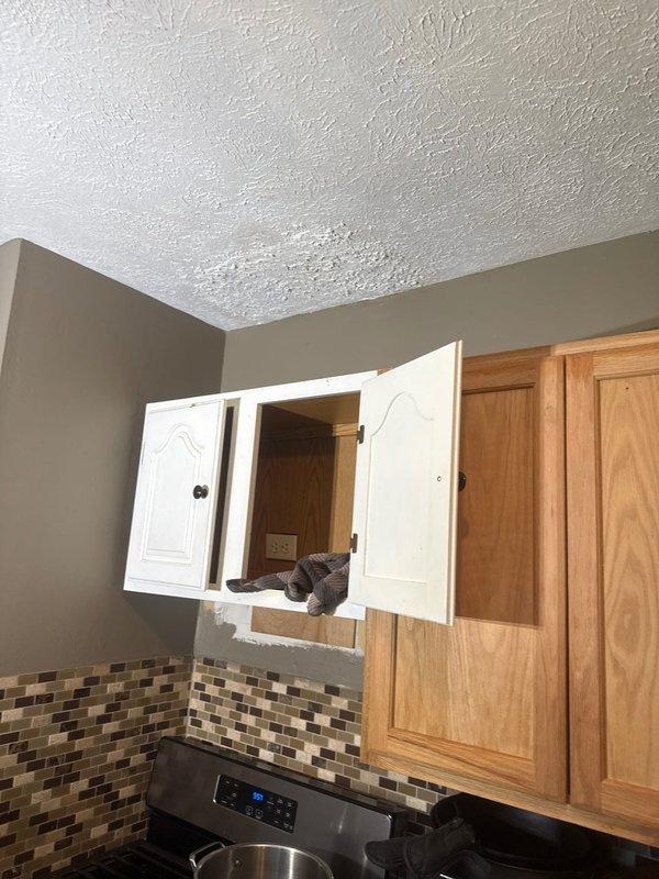Returned to address leaking issue from previous repair under warranty callback. Inspected kitchen and bathroom plumbing fixtures shown in documentation photos. Identified source of leak, made necessary corrections to ensure proper seal and function, and verified system was operating without further water discharge upon completion.