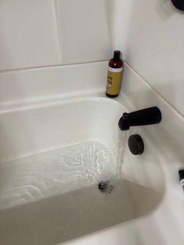 Returned to address leaking issue from previous repair under warranty callback. Inspected kitchen and bathroom plumbing fixtures shown in documentation photos. Identified source of leak, made necessary corrections to ensure proper seal and function, and verified system was operating without further water discharge upon completion.