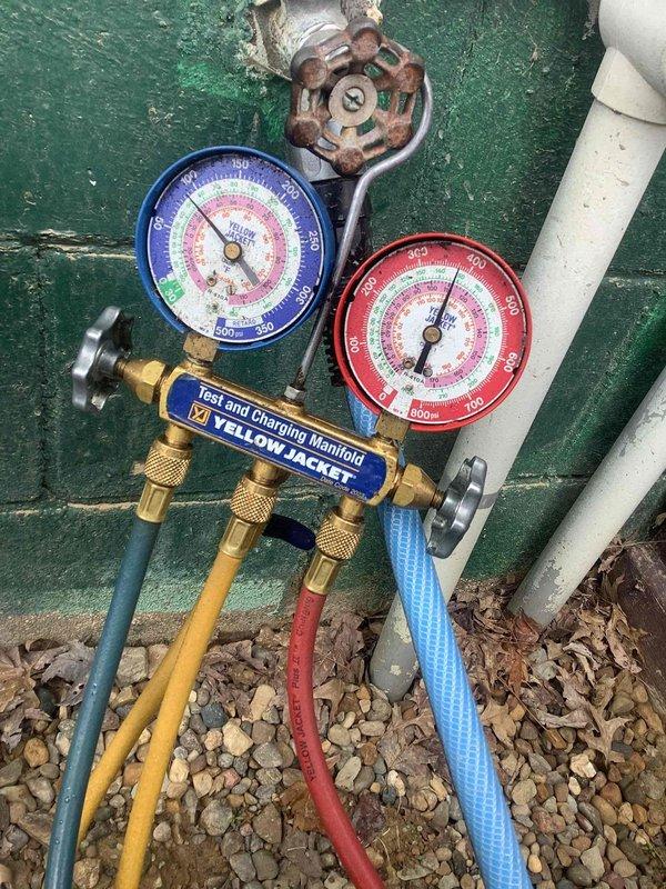 Responded to no cooling complaint with thermostat reading 80°F. Upon arrival, connected manifold gauges to aging outdoor unit and performed system diagnostics. Visual inspection revealed heavily corroded service valves and weathered components, indicating advanced age and exposure damage. Evaluated refrigerant pressures, electrical connections at outdoor disconnect, and overall system condition to determine cause of inadequate cooling performance.