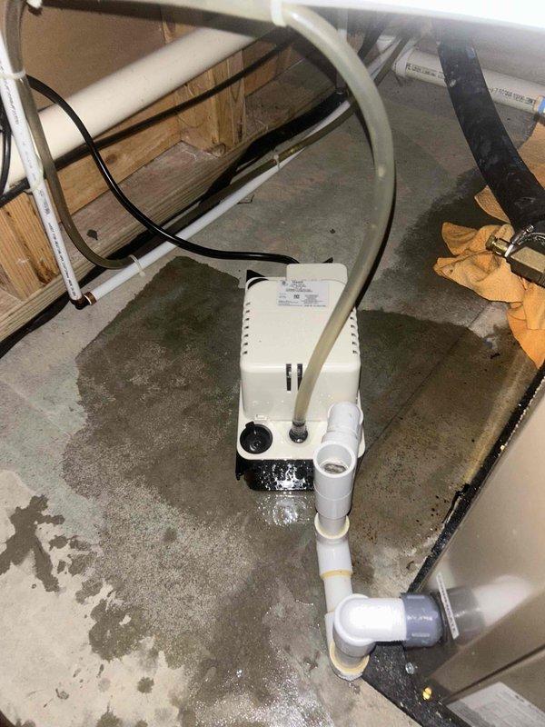 Responded to callback for water leakage around geothermal system that began within the last 48 hours. Inspected Carrier HVAC unit, condensate pump assembly, and associated PVC drainage lines in basement mechanical room. Identified source of water accumulation on concrete floor near condensate removal device, verified pump operation, checked drain line connections and discharge routing, and addressed the leakage issue to restore proper system function.