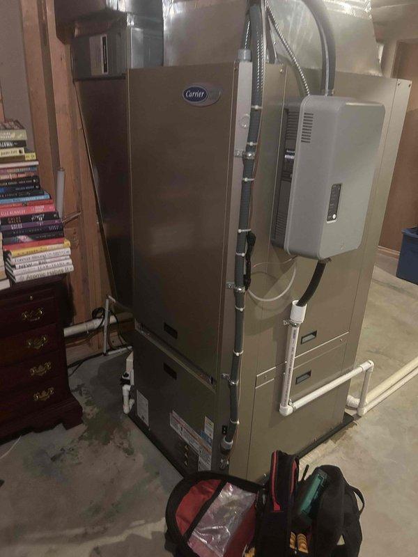Responded to callback for water leakage around geothermal system that began within the last 48 hours. Inspected Carrier HVAC unit, condensate pump assembly, and associated PVC drainage lines in basement mechanical room. Identified source of water accumulation on concrete floor near condensate removal device, verified pump operation, checked drain line connections and discharge routing, and addressed the leakage issue to restore proper system function.