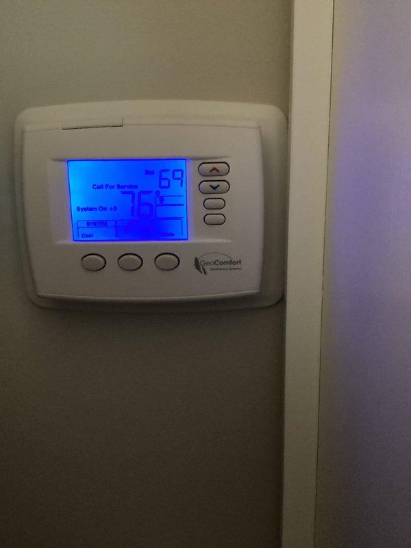 Responded to no cooling call on geothermal system. Upon arrival, found thermostat displaying "Call For Service" message with indoor temperature at 78°F and setpoint at 68°F. Inspected geothermal heat pump unit and internal components including blower motor, wiring connections, and refrigerant lines. Performed diagnostic testing to identify system fault causing cooling failure and restored system to proper operation.