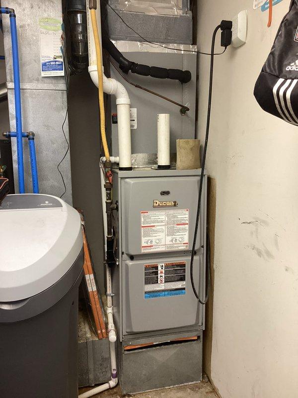 Performed comprehensive air conditioning tune-up on residential split system including Ducane furnace with air handler and outdoor condenser unit. Inspected all refrigerant lines, electrical connections, and condensate drainage system for proper operation. Cleaned condenser coils, verified airflow through evaporator, checked system pressures and temperatures, and confirmed all safety controls and thermostatic operation within manufacturer specifications.