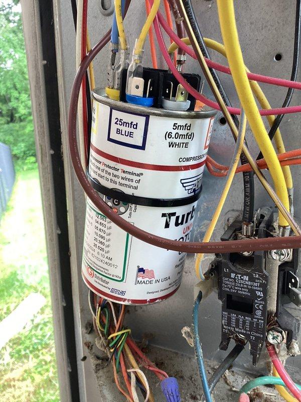 Replaced failed condenser fan motor on outdoor HVAC unit. Verified proper electrical connections to dual-run capacitor (25/5 MFD) and contactor assembly. System tested and confirmed operational with R-410A refrigerant pressures within normal range at 973 PSIG high side and 219.9 PSIG low side, with appropriate superheat and subcooling values.