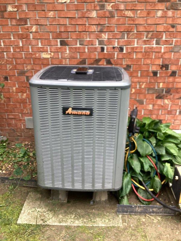 Performed diagnostic evaluation on Amana condensing unit experiencing compressor failure. Connected manifold gauges and recorded system pressures, confirming compressor malfunction with abnormal pressure readings of 119.9 PSI on low side and 267.5 PSI on high side. Scheduled return visit to replace failed compressor and restore system operation.