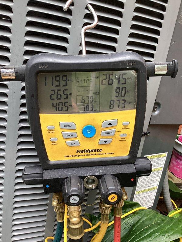 Performed diagnostic evaluation on Amana condensing unit experiencing compressor failure. Connected manifold gauges and recorded system pressures, confirming compressor malfunction with abnormal pressure readings of 119.9 PSI on low side and 267.5 PSI on high side. Scheduled return visit to replace failed compressor and restore system operation.