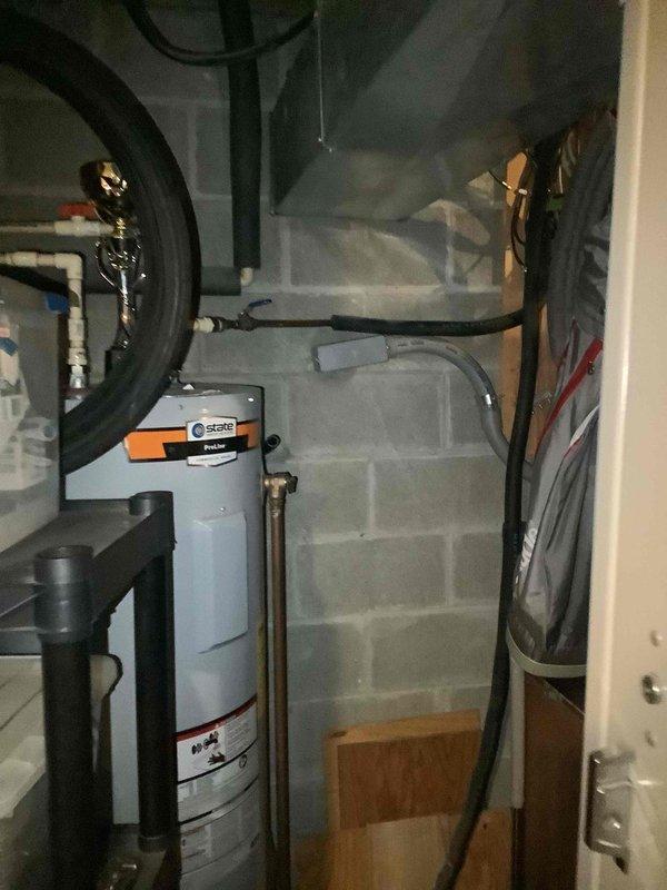 Completed basic monthly HVAC maintenance service on geothermal cooling system. During inspection, identified active water leak at connection point where geothermal system interfaces with water heater in utility room. Documented leak condition with photos showing water heater, pressure tank, and plumbing connections for follow-up repair recommendation.