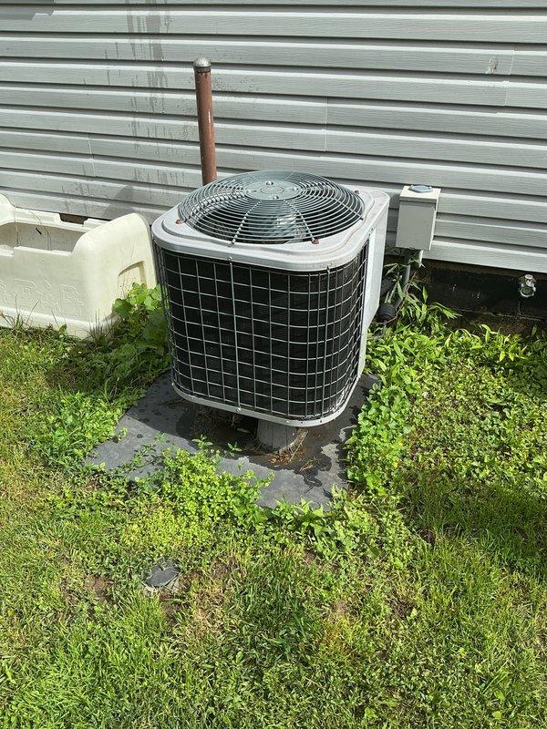 Completed cooling tune-up on residential air conditioning system. Performed comprehensive maintenance on outdoor condensing unit including inspection of compressor operation, refrigerant line connections, and fan assembly. Verified proper electrical connections at disconnect box, cleaned condenser coil, and confirmed adequate airflow through protective grille. Inspected indoor Honeywell thermostat for proper operation and calibration, noting system currently set to 67 degrees. All components tested and operating within normal parameters with no deficiencies identified.