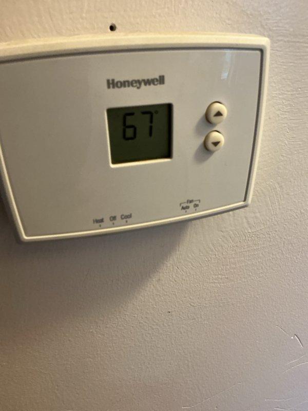 Completed cooling tune-up on residential air conditioning system. Performed comprehensive maintenance on outdoor condensing unit including inspection of compressor operation, refrigerant line connections, and fan assembly. Verified proper electrical connections at disconnect box, cleaned condenser coil, and confirmed adequate airflow through protective grille. Inspected indoor Honeywell thermostat for proper operation and calibration, noting system currently set to 67 degrees. All components tested and operating within normal parameters with no deficiencies identified.
