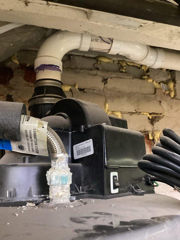 Responded to water heater leak complaint and conducted thorough inspection of the unit and surrounding plumbing infrastructure. Upon assessment, documented the mechanical room conditions, water treatment system, and associated plumbing connections including condensate pump assembly and drainage piping. Photographed the installation for service records, capturing the water softener system, pressure tank, and plumbing connections with proper insulation and drainage components to determine source of reported leak and recommend appropriate corrective action.