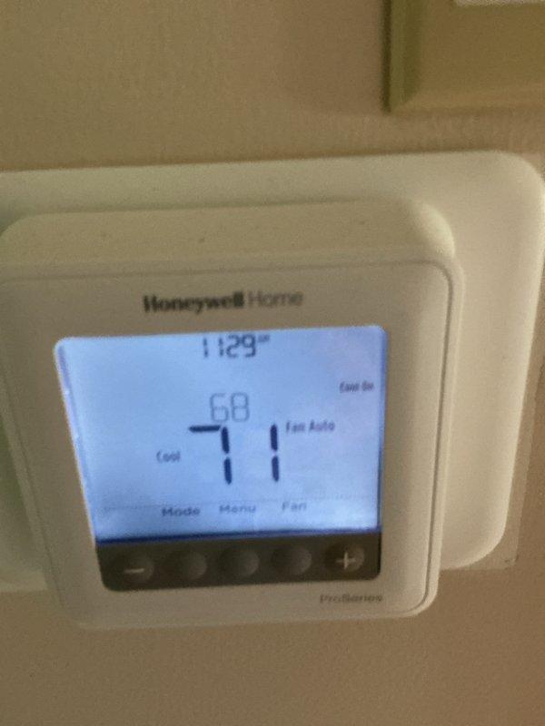 Performed comprehensive cleaning and inspection of HVAC system. Verified thermostat operation showing 71°F setpoint with system in cooling mode and auto fan configuration. Inspected water heater and associated plumbing connections, confirming proper installation of safety drain pan and secure pipe fittings with appropriate caps in place.