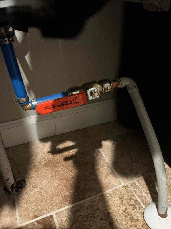 Completed prepaid plumbing inspection of residential property, coordinating timing with HVAC service between 10-12. Inspected and documented water supply line installation in utility closet, including blue PVC piping with orange ball valve shut-off and brass compression fittings. Examined bathroom plumbing fixtures including bathtub with chrome single-handle faucet assembly, tub spout, and drain. All components photographed for record. No immediate repairs required at time of inspection.