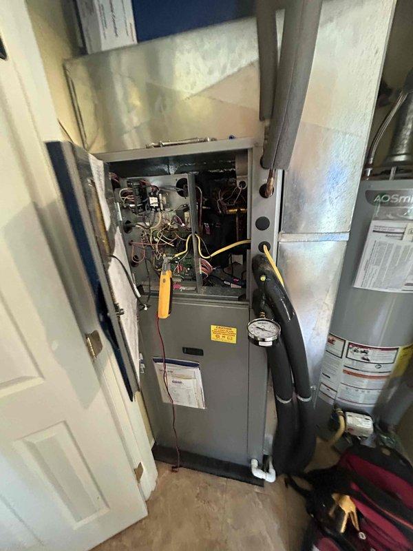 Responded to no cooling complaint and performed troubleshooting on split system air conditioning unit. Inspected exterior disconnect box and found accumulated debris, dust buildup, and aged fuse assembly with visible wear on terminals and connections. Examined indoor air handler unit with front access panel removed, revealing internal electrical components, control board, and wiring connections requiring attention to restore proper operation.