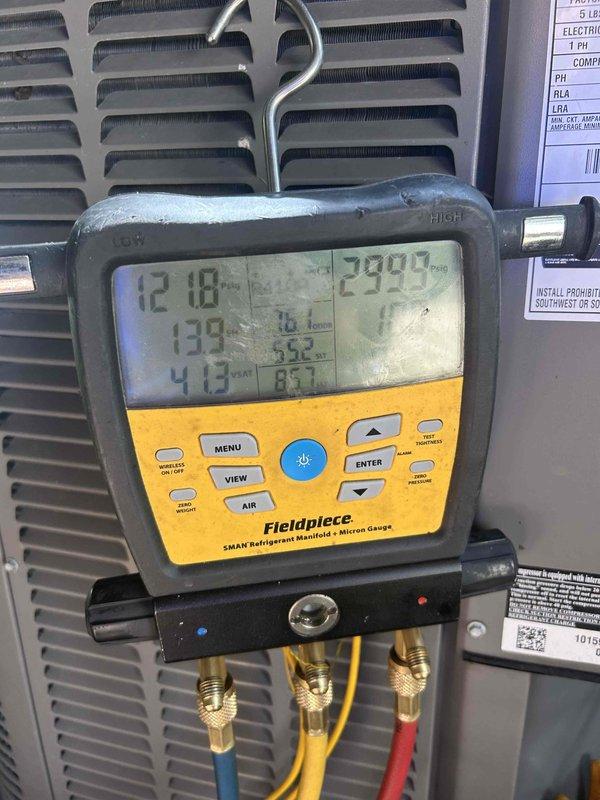 Responded to no cooling complaint on central air conditioning system. Upon arrival, found refrigerant lines frozen at outdoor unit, indicating low refrigerant charge or restricted airflow. Inspected indoor evaporator coil and ductwork, noting 16x20x1 filter size and some discoloration on insulation components. Connected Fieldpiece SMAN manifold gauges to service ports and recorded system pressures and temperatures. Suction pressure reading of 133 PSI and discharge pressure of 413 PSI confirmed abnormal operating conditions. Diagnosed low refrigerant charge as primary cause of freezing and loss of cooling capacity. Allowed system to thaw completely before proceeding with repairs. Located and repaired refrigerant leak, then evacuated system to proper vacuum levels. Recharged system to manufacturer specifications and verified proper operation. Monitored system performance until pressures stabilized and confirmed adequate cooling output. Replaced air filter and advised on proper maintenanc