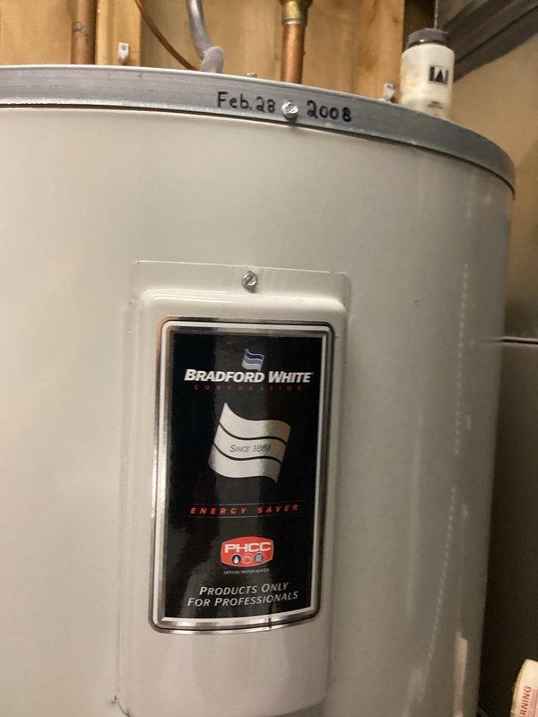 Responded to water heater leak complaint and performed thorough inspection of Bradford White 80-gallon residential unit installed in 2008. Upon examination, documented the water heater's current condition, specifications, and installation setup including copper supply lines and venting system. Photographed unit identification labels showing model M2B0R6DS-1NCWW with serial number EA10105999, rated at 4500/3500 watts with 150 psi maximum working pressure. Assessed the overall system integrity and documented findings for repair recommendations.