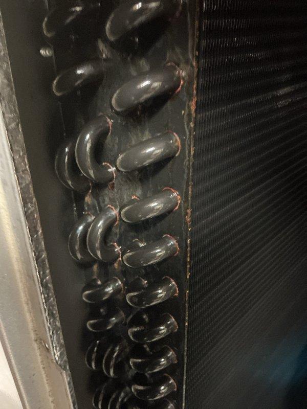 Completed annual cooling maintenance visit on residential HVAC system. Performed comprehensive inspection of evaporator coil, noting oxidation on copper tubing and minor corrosion at tube connections consistent with normal aging. Inspected finned heat exchanger assembly and documented condition. Serviced EAC filter system, disassembling filter housings and cleaning mesh filter media. Verified all system components operational and discussed customer inquiry regarding water heater flushing service for future scheduling.