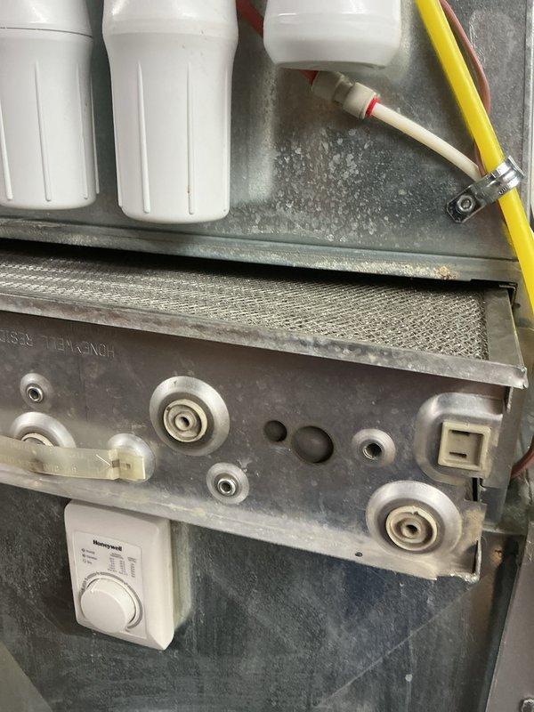 Completed annual cooling maintenance visit on residential HVAC system. Performed comprehensive inspection of evaporator coil, noting oxidation on copper tubing and minor corrosion at tube connections consistent with normal aging. Inspected finned heat exchanger assembly and documented condition. Serviced EAC filter system, disassembling filter housings and cleaning mesh filter media. Verified all system components operational and discussed customer inquiry regarding water heater flushing service for future scheduling.