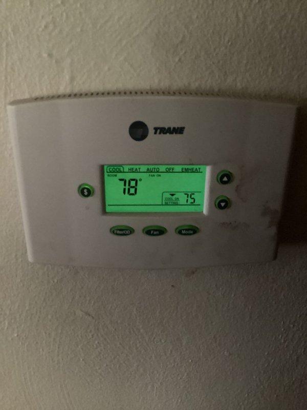 Responded to callback for system not cooling following previous frozen evaporator coil issue. Upon arrival, verified thermostat set to cooling mode at 75°F with current room temperature reading 78°F. Confirmed system had thawed from previous freeze-up condition but was no longer providing adequate cooling. Inspected Trane thermostat operation and settings, documented current system status with photos showing display readings and mode selections.