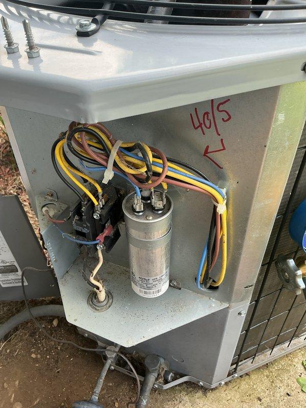 Completed CCC Basic Monthly maintenance on cooling system. Inspected and documented electrical components including 40/5 capacitor and contactor within outdoor unit panel, verified proper wire connections and cable management. Replaced 20x20x1 air filter per service agreement. Confirmed thermostat operation with system maintaining 70-degree setpoint and displaying 74-degree ambient temperature reading.