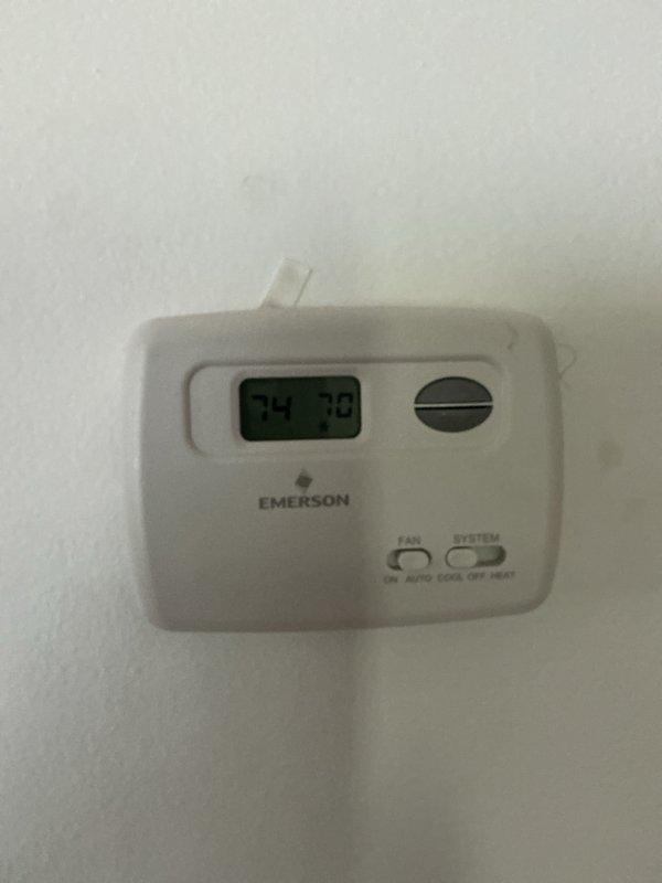 Completed CCC Basic Monthly maintenance on cooling system. Inspected and documented electrical components including 40/5 capacitor and contactor within outdoor unit panel, verified proper wire connections and cable management. Replaced 20x20x1 air filter per service agreement. Confirmed thermostat operation with system maintaining 70-degree setpoint and displaying 74-degree ambient temperature reading.
