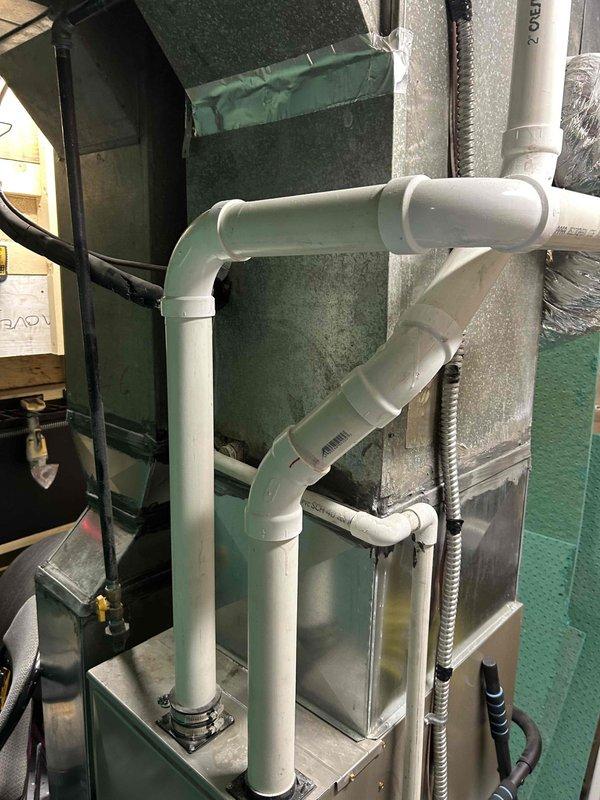 Responded to no cooling complaint on residential HVAC system less than 10 years old. Inspected condensate drainage system including copper refrigerant lines and PVC drain piping configuration in mechanical room. Verified proper installation of ductwork connections, air handler unit, and flexible ducting components to ensure system functionality and proper condensate removal.
