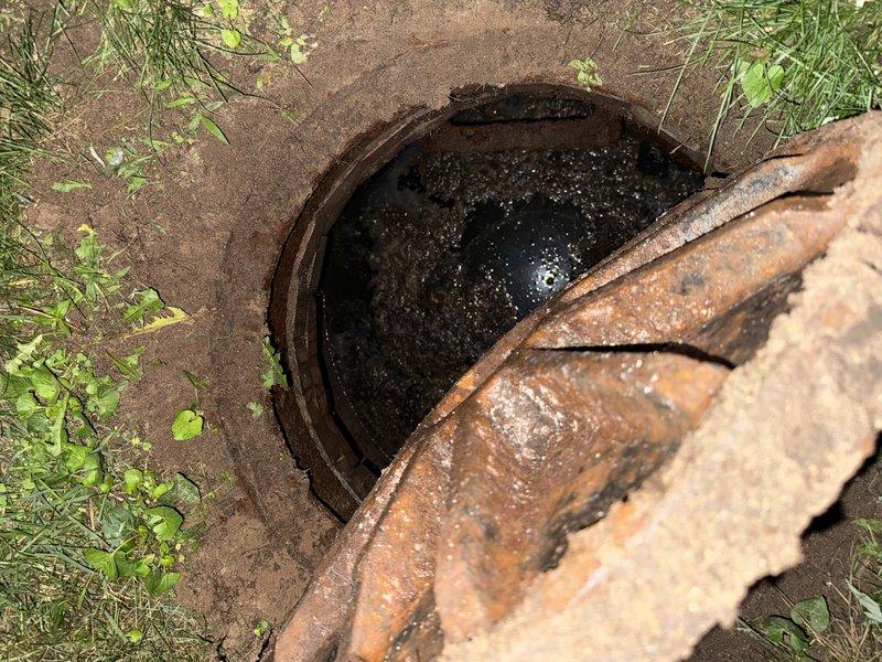 Responded to clogged main drain line. Located and accessed ground-level cleanout, which showed significant deterioration with heavy rust on metal cover and corroded rim components. Upon opening access point, found standing water with sediment and debris accumulation in the basin, indicating complete blockage in the main sewer line. Performed mechanical cable augering through the main drain to clear obstruction and restore proper flow. Removed accumulated debris and sediment from cleanout basin. Verified drainage system functionality and confirmed water flow resumed normally through the line. Recommended monitoring for recurring issues and future cleanout replacement due to advanced deterioration of access components.