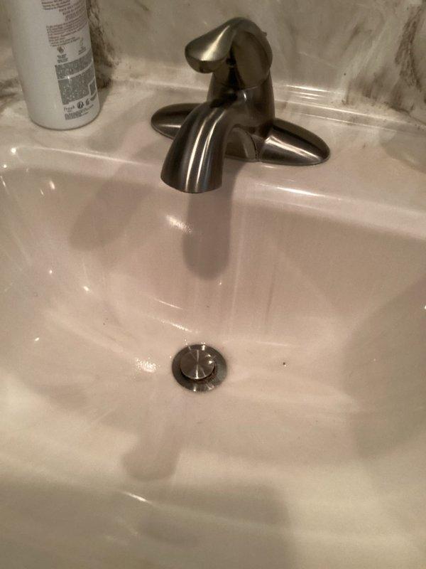 Responded to service call for clogged bathroom sink drain. Upon arrival, inspected the sink basin and drain assembly, noting slow drainage issue. Removed and cleaned the pop-up drain stopper, which had accumulated debris and hair buildup causing the blockage. Tested drain flow after clearing obstruction to confirm proper drainage was restored. Sink is now functioning normally with no standing water or slow drainage issues.