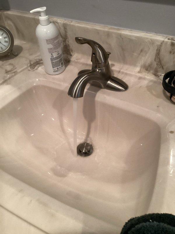 Responded to service call for clogged bathroom sink drain. Upon arrival, inspected the sink basin and drain assembly, noting slow drainage issue. Removed and cleaned the pop-up drain stopper, which had accumulated debris and hair buildup causing the blockage. Tested drain flow after clearing obstruction to confirm proper drainage was restored. Sink is now functioning normally with no standing water or slow drainage issues.